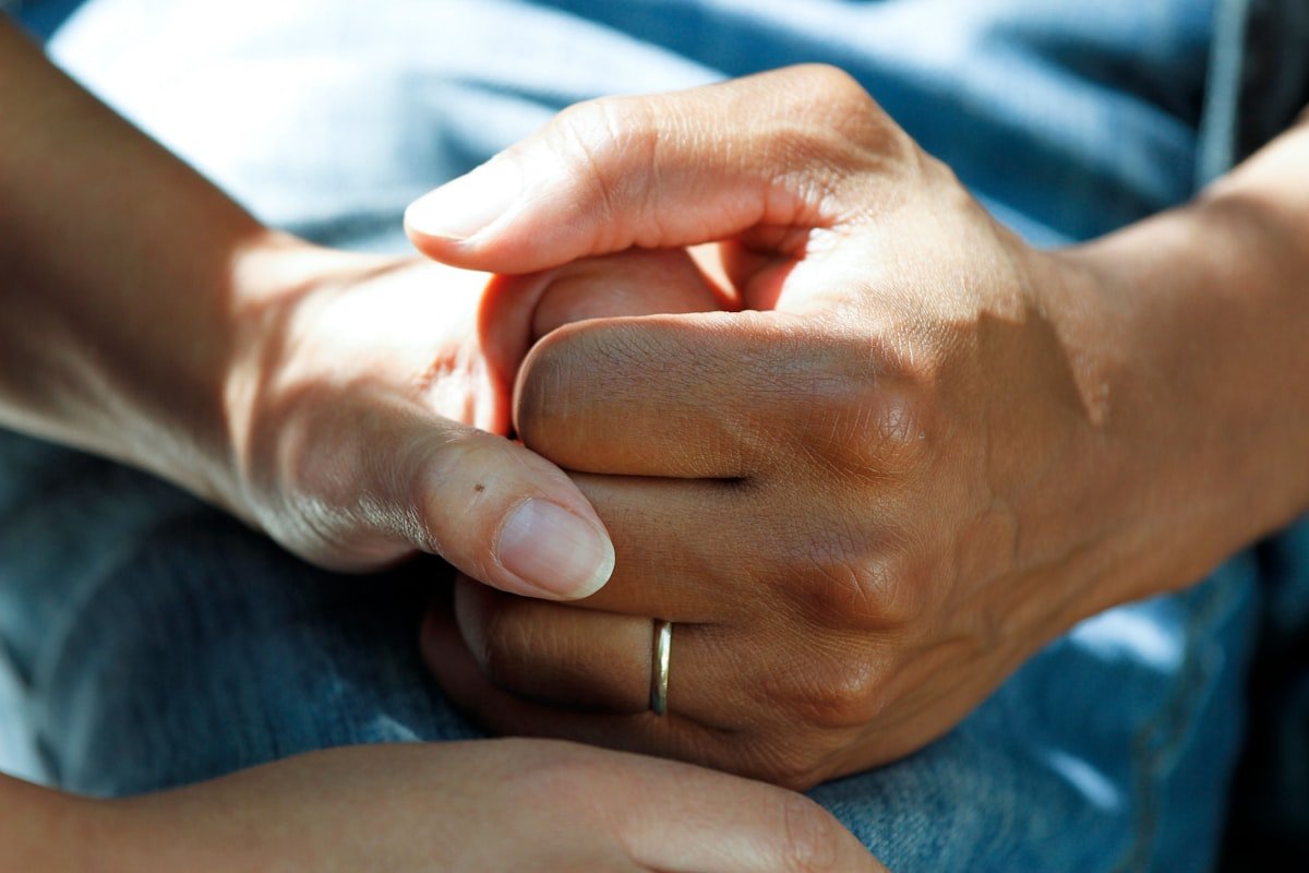 Supportive hands representing compassionate medical transportation care